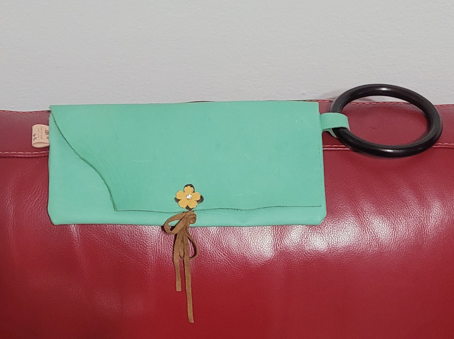 Light green leather clutch with wood handle