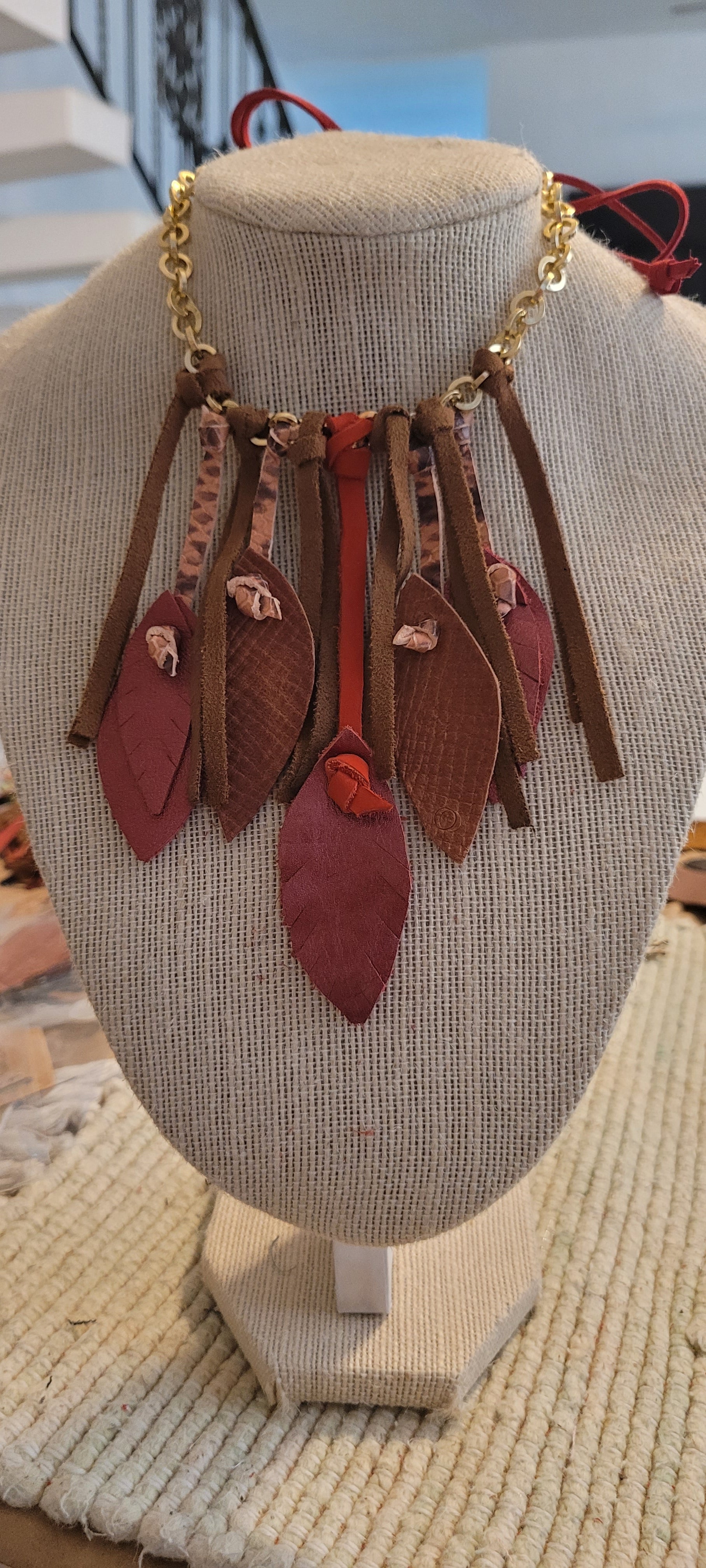 Necklace with leather leaf and charms
